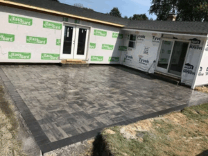 Patio installation showing a neatly paved area with modern pavers.