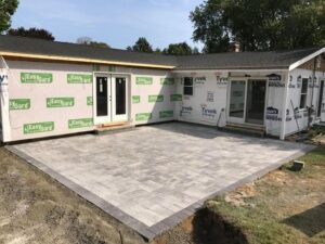 Completed patio installation featuring uniform pavers and a clean finish.