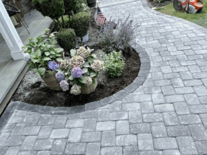 Stone walkway installation with curved paver design.