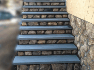 Back entrance staircase made of natural stone and concrete steps