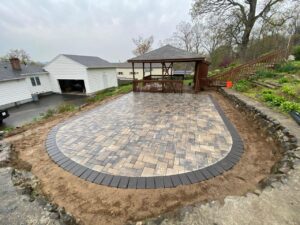 Patio paver installation with defined dark border and gazebo