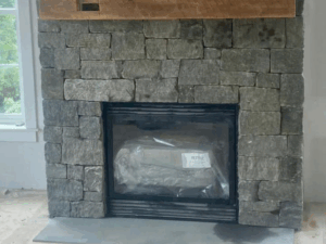 stone fireplace installation with natural stonework and custom mantel