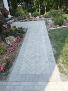 Paver walkway installation overview, detailing its structural benefits, property value enhancement, and the need for professional execution.